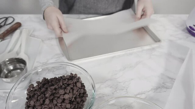 Step by step. Ingredients to prepare chocolate dipped strawberries on a marble surface.
