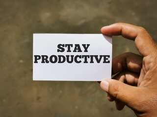 Selective focus image with noise effect hand holding white card with text STAY PRODUCTIVE.Business concept.