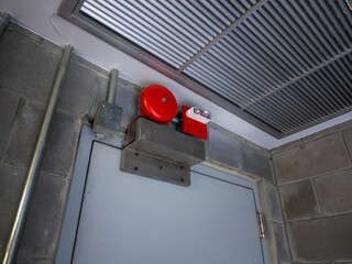 Electric red fire ring bell alarm on the wall
