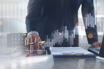 Business analysis concept. Businessman analyzing sales data, financial report with stock market graph chart on virtual screen interface