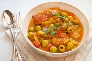 Traditional tagine plate with chicken, lemon and olive