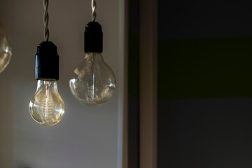 Two large bulbs hang from the ceiling. close-up