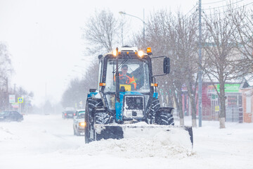 Old tractor removes snow from the road
