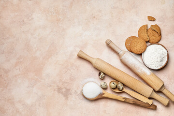 Ingredients for cookies and rolling pins on color background