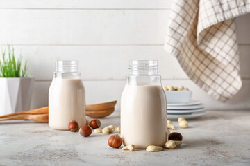 Bottles of different vegan milk on table