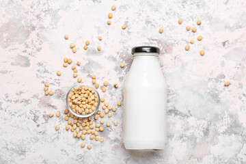 Bottle of tasty soy milk on light background