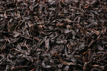 Dry black tea leaves as background