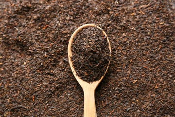 Spoon of dry black tea leaves, closeup