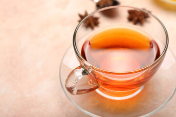 Cup of hot aromatic tea on light background