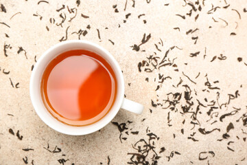 Cup of hot aromatic tea on light background