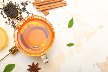 Cup of hot aromatic tea on light background