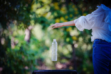 Woman hand picking up garbage plastic for cleaning at park
