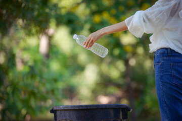 Woman hand picking up garbage plastic for cleaning at park