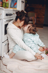 Fototapeta premium Cute little girl with mother. Family at home. Mother with daughter in a room