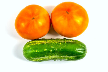 Stock Foto Closeup of yellow orange tomato and cucumber isolated on white background