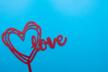 Red abstract heart and text "Love" on blue background