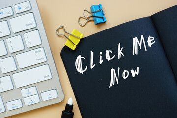 Click Me Now inscription on the piece of paper.