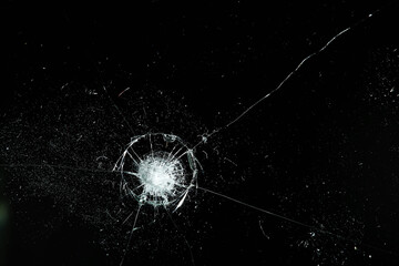 cracks on black glass background, broken abstract glass hole destruction concept