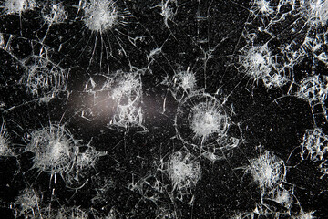 cracks on black glass background, broken abstract glass hole destruction concept