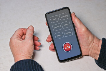 An elderly woman presses the SOS help button on the smartphone. Hands of an old man. Panic button,...