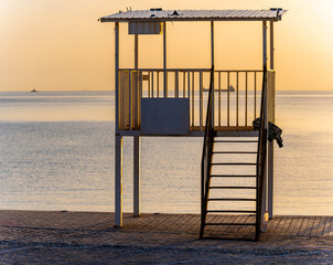 Life guard tower at sunset on coast