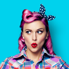 Excited surprised woman. Pinup girl looking sideways. Purple head model at retro fashion and...