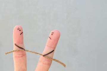 Fingers art of couple. They playing tug of war with rope.