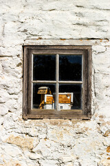 Small house in the window of an old cottage