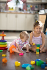 Fototapeta premium Two children play toys