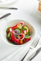Classic Greek salad. Banquet festive dishes. Gourmet restaurant menu. White background.