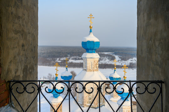 city view from the high bell tower. panorama of Cherdyn (Russia). in the foreground are the blue domes of an old church, in the distance a frozen river and houses of the winter city