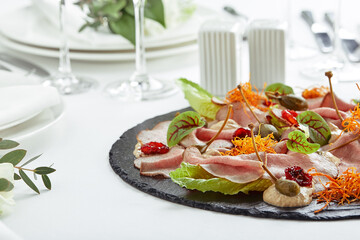 Beautifully decorated catering banquet table with different food snacks and appetizers