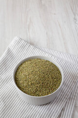 Organic Dried Rosemary in a Bowl, side view. Copy space.