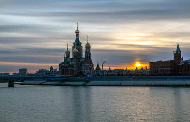 Theatrical bridge over Malaya Kokshaga with a view of the Annunciation Cathedral at sunset. Yoshkar-Ola. Mari El Republic. Russia