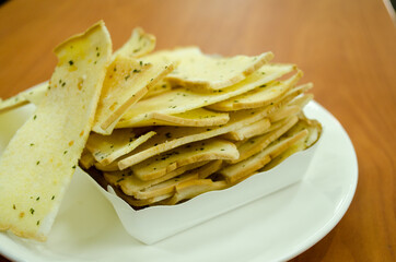 crispy bread butter with garlic on white plate