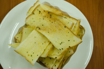 crispy bread butter with garlic on white plate