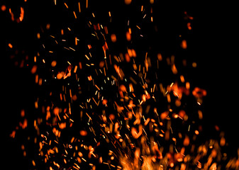 Fototapeta na wymiar fire flame with sparks on black background