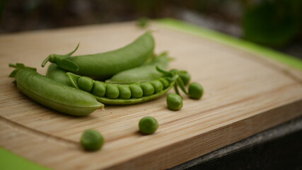Organic Peas on modern chopping board