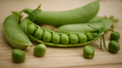 Organic Healthy Sugar Snap Peas in pod on wooden background