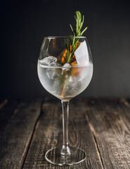Gin based cocktail with triple sec in wine glass on the rustic background. Selective focus. Shallow depth of field. 