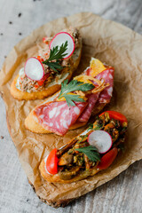 wooden board with tasty fresh bruschettas on table
