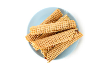 Plate with wafer rolls with condensed milk isolated on white background