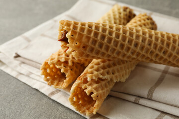 Napkin with wafer rolls with condensed milk on gray background