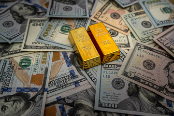 Gold bars on 100 US Dollar note as  background