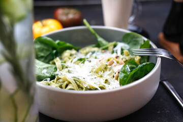Pasta with green pesto with spinach, pine nuts and parmesan cheese.
Food served on a plate, food styling, serving suggestions, culinary photography