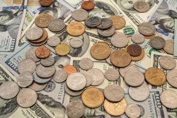 US coins on dollar bills background