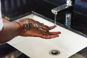 Closeup washing black man hands rubbing with soap and water in sinks to prevent outbreak coronavirus hygiene to stop spreading virus, hygiene for quarantine cleaning COVID-19 concept