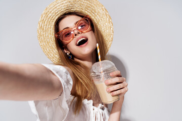 Cheerful pretty woman in pink glasses emotions hat in a glass with a luxury drink