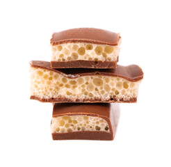 Tasty porous chocolate, isolated on white background. White aerated chocolate.