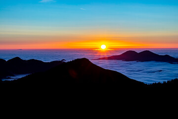 Sunrise with sea of clouds in horizon	